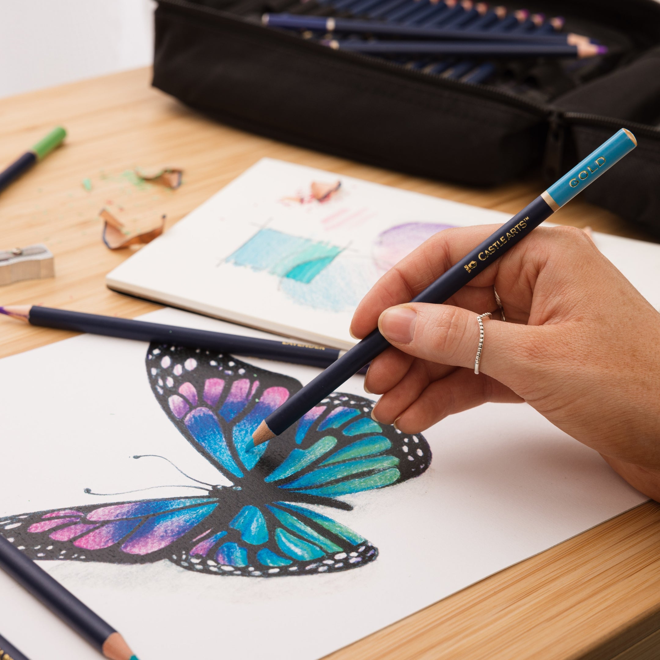 woman drawing with blue coloured pencil